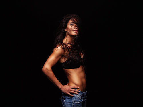 Sexy woman posing in bra and jeans