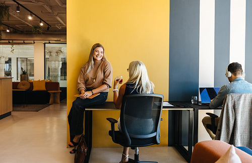 Professional workspace featuring colleagues working and communicating in a modern office setting