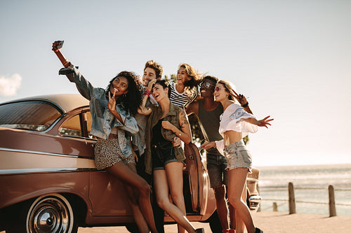 Diverse friends on road trip taking selfie