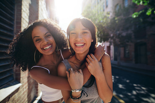 Two young women having fun on city street