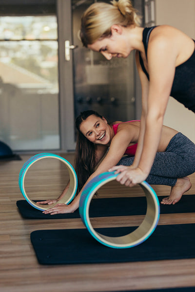 Women practicing pilates workout at a gym