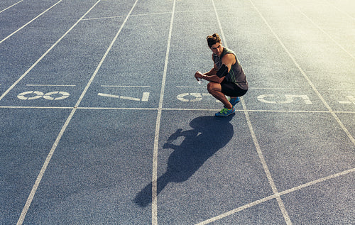 Sprinter sitting on running track