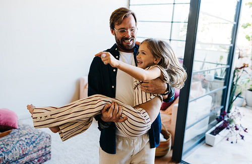 Family joy as dad carries girl indoors