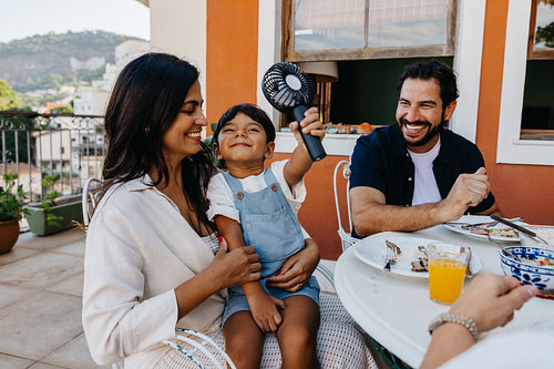 Smiling family enjoying a lively outdoor gathering in warm weather