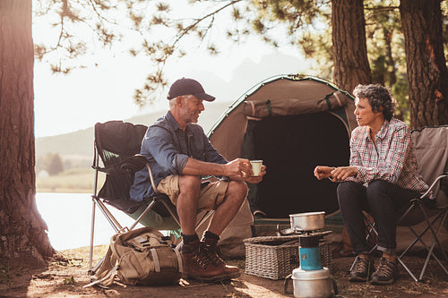 Campers enjoying coffee by the lake