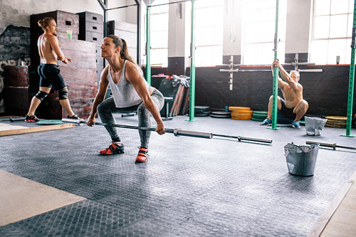 Fit people exercising in crossfit gym