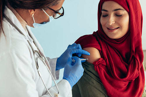 Muslim woman getting flu shot