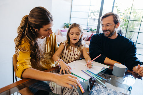 Family drawing session with mom, dad, and daughter