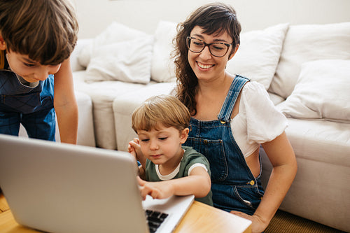 Happy family with laptop at home