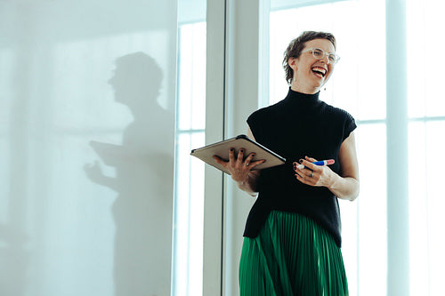 Non-binary businessperson presenting with whiteboard