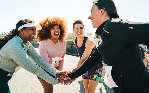 Group of diverse female runners bonding before a race