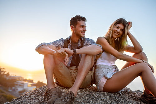 Couple of hikers relaxing on hill top