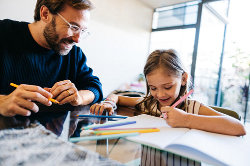 Father and daughter drawing together