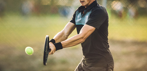 Tennis player swatting the ball 