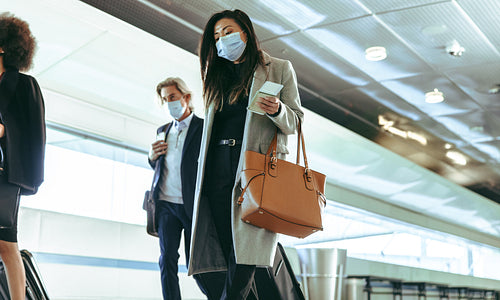 Travelers at airport terminal post pandemic lockdown