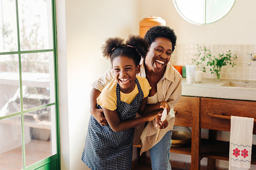Happy family baking between a mother and daughter in a Brazilian kitchen