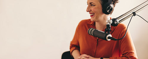 Cheerful woman interviewing a guest on her radio show