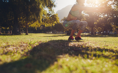 Woman practicing squat exercise at the park