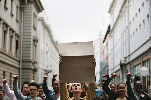 Protestors on the street holding sign board
