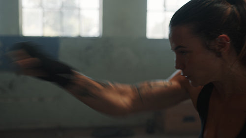 Female boxer practising her moves in gym