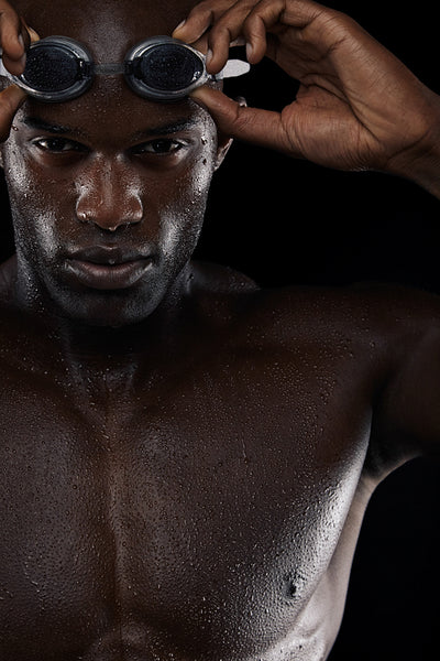 Young african swimmer with goggles