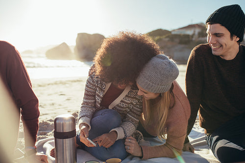 Women with friends having fun on the beach