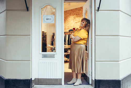 Businesswoman standing at her boutique doorway