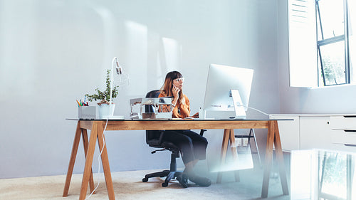 Businesswoman working on computer sitting in office