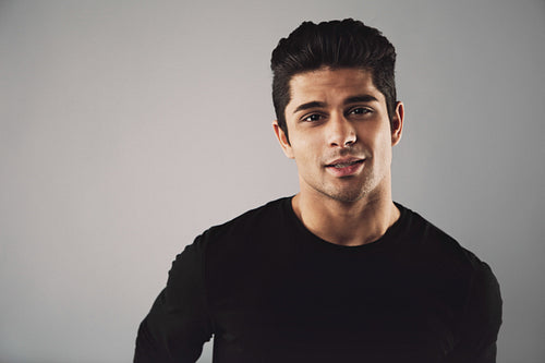 Young man in casual t-shirt looking at camera