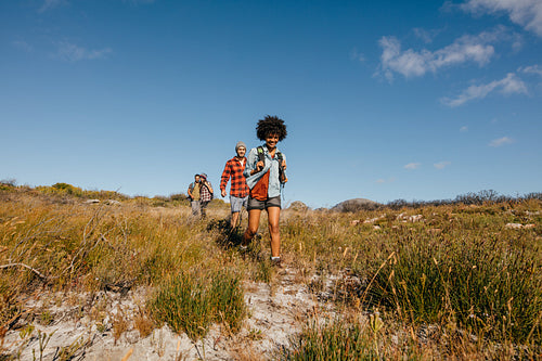 Group of friends walking through countryside