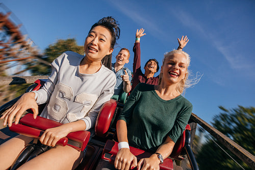 Group of friends on a thrilling roller coaster ride