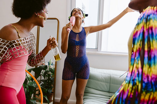 Friends celebrate at home with colorful party outfits