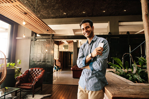 Creative professional in office lounge during break