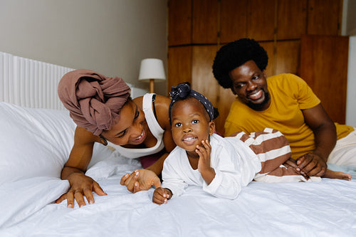 Family relaxing together on a bed