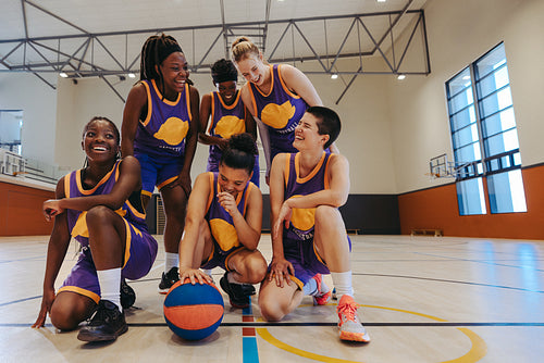 Victory framed: Female basketball team celebrates with a group photo