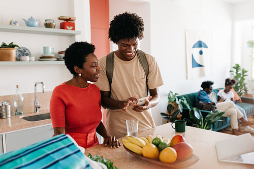 Happy family morning: Mother and son in kitchen preparing breakfast together