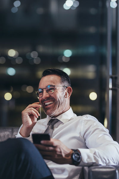 Businessman talking on phone at airport lounge