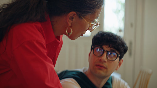 Woman mentors man at laptop during business training session