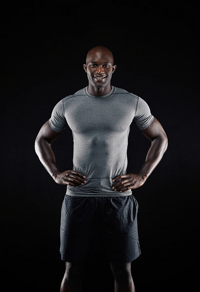 Happy young african man standing confidently