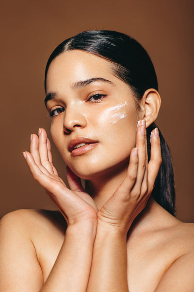 Woman taking control of her beauty by pampering her skin with healthy facial cream