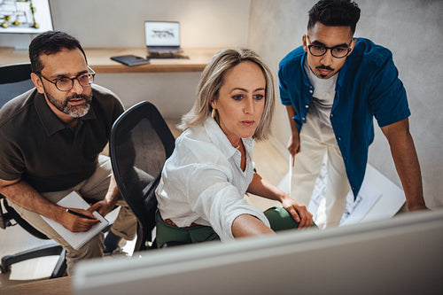 Professional collaboration of architects discussing a project in a modern office