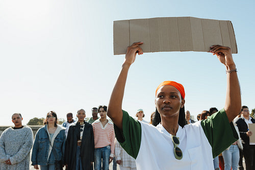 Female activist holding a blank sign during a protest for change