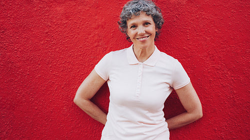 Happy middle aged woman standing relaxed