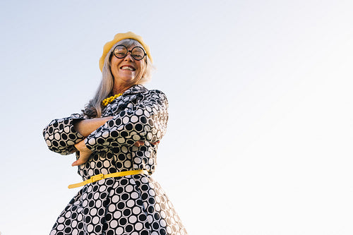 Excited elderly woman smiling at the camera outdoors
