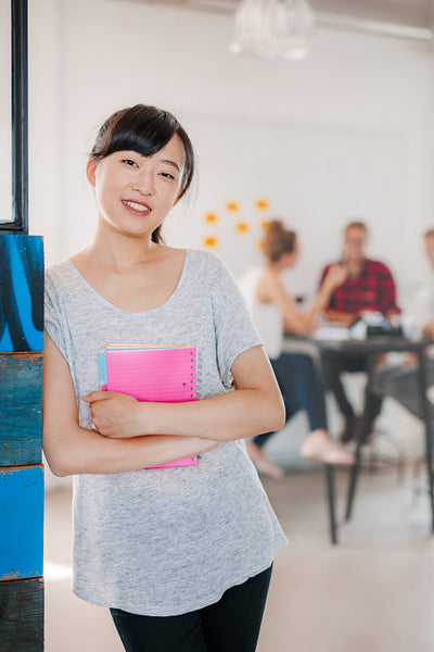 Positive businesswoman standing in office