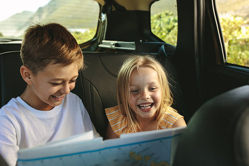 Kids  playing with map in car