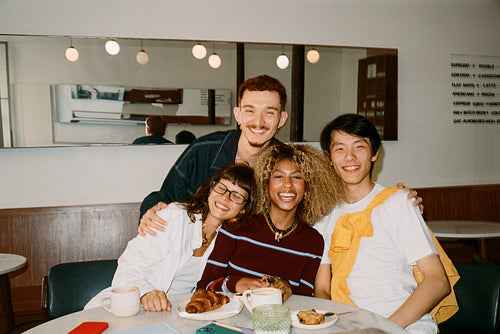 Friends at cafe enjoying coffee and pastries