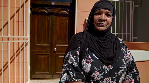 Senior islamic woman in black hijab outside