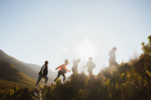 Group hiking on a sunny hill