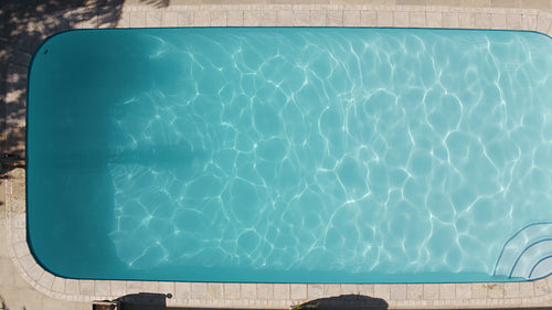 Woman with swimsuit swimming on a blue water pool